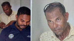 ބުޅަލަށް ވަޅި ޖެހި މީހާ (ކ) އާއި މަގުމަތީ މާރާމާރީން އޭނާ ސަލާމަތްކުރި ފުލުސް މީހާ (ނޫ ޔުނީފޯމުގައި) --އަދިވެސް ފޮޓޯ: