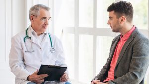 Senior doctor consults young patient