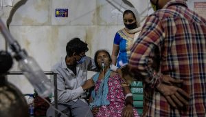 A woman with a breathing problem receives oxygen support for free at a Gurudwara, in Ghaziabad