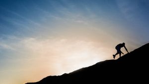 A man climbing up a mountain.