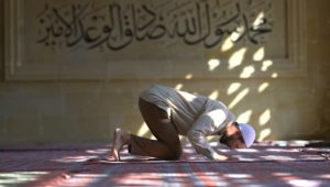 Muslim man praying in mosque, Turkey