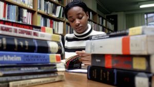 University student studying in library.